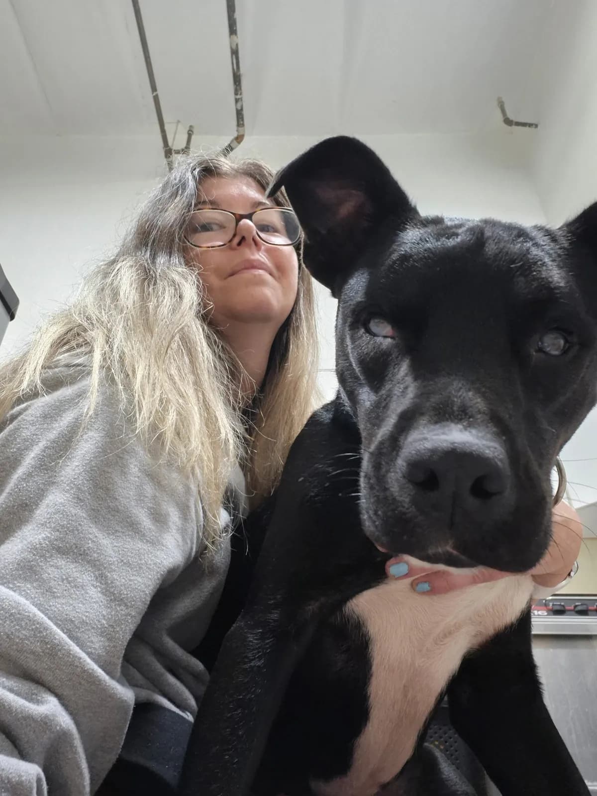 Sarah and a black dog in a selfie